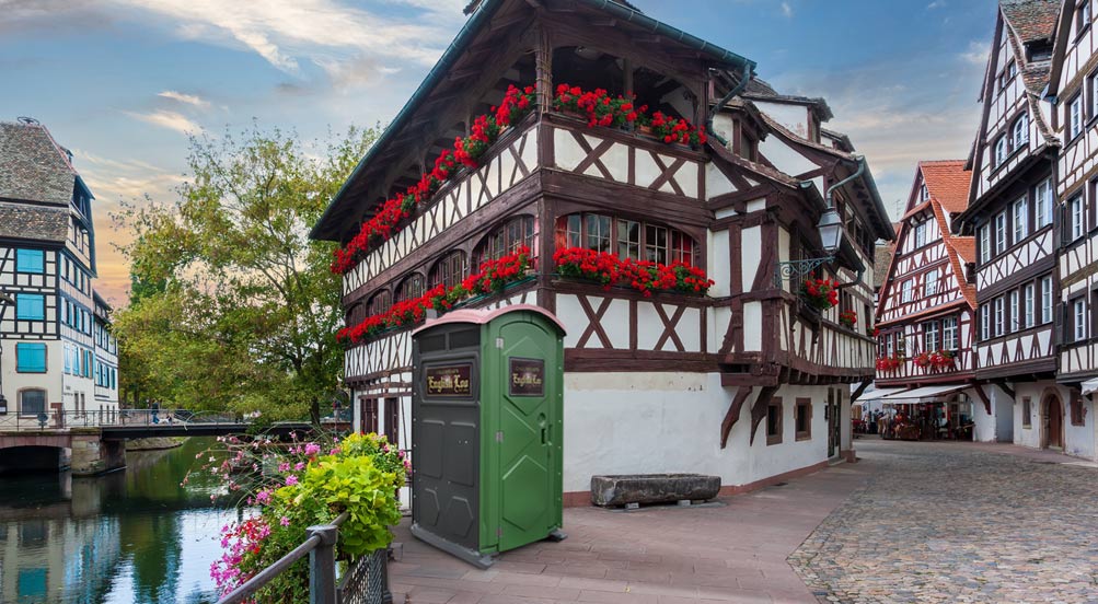 English Loo | English Loo in front of a half timber frame building with red flower planters.