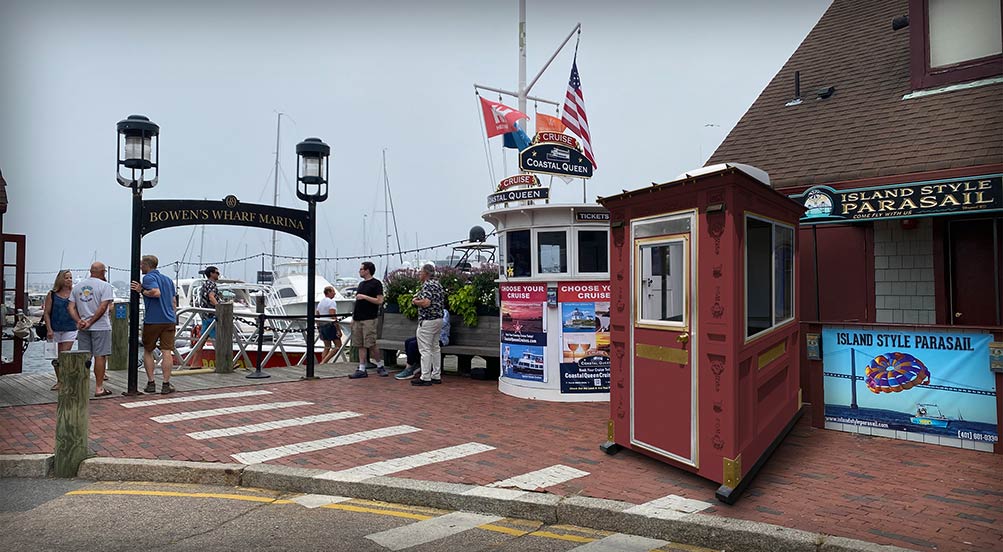 Valet Key Booth 16 | Valet Key Booth 16 in front of a marina in the summer.